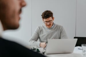 Professional working on a laptop as organizations navigate AI anxiety in the workplace