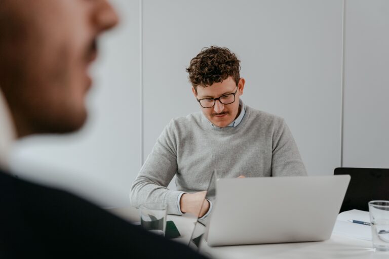 Professional working on a laptop as organizations navigate AI anxiety in the workplace